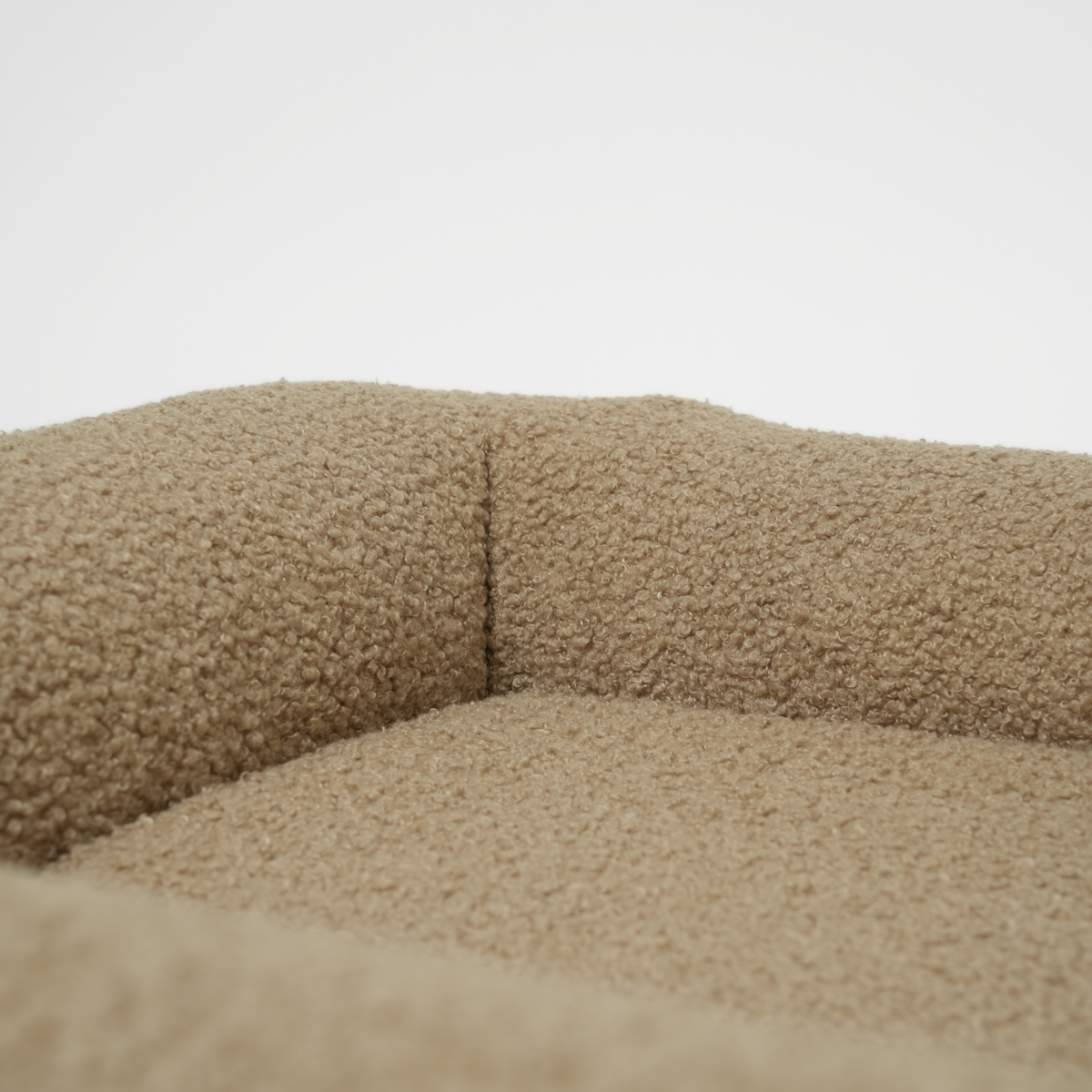 Lähikuva Moss Curly Bouclé -koiranpetin selkänojasta ja tyynystä